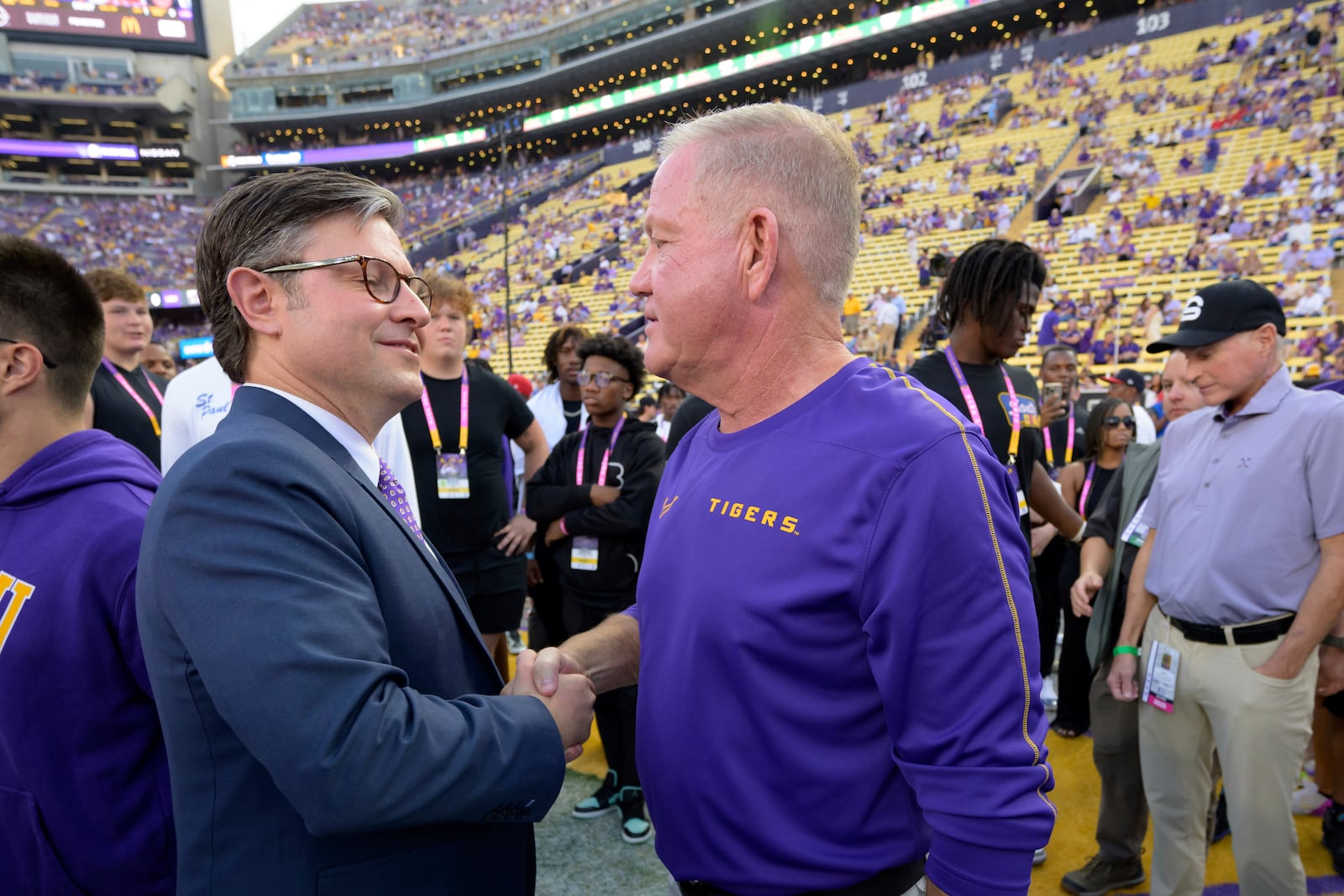 U.S. Speaker of the House, Rep. Michael Johnson (R-La.) greets LSU head coach Brian Kelly before an NCAA college football game against Mississippi in Baton Rouge, La., Saturday, Oct. 12, 2024. (AP Photo/Matthew Hinton)