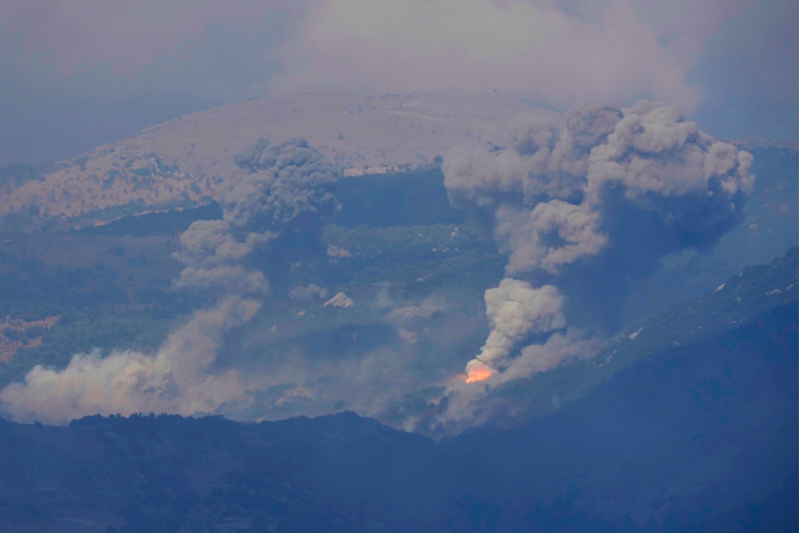 Smoke rises from Israeli airstrikes on Mahmoudiyeh mountains, as seen from Marjayoun town, south Lebanon, Saturday, Sept. 21, 2024. (AP Photo/Hussein Malla)