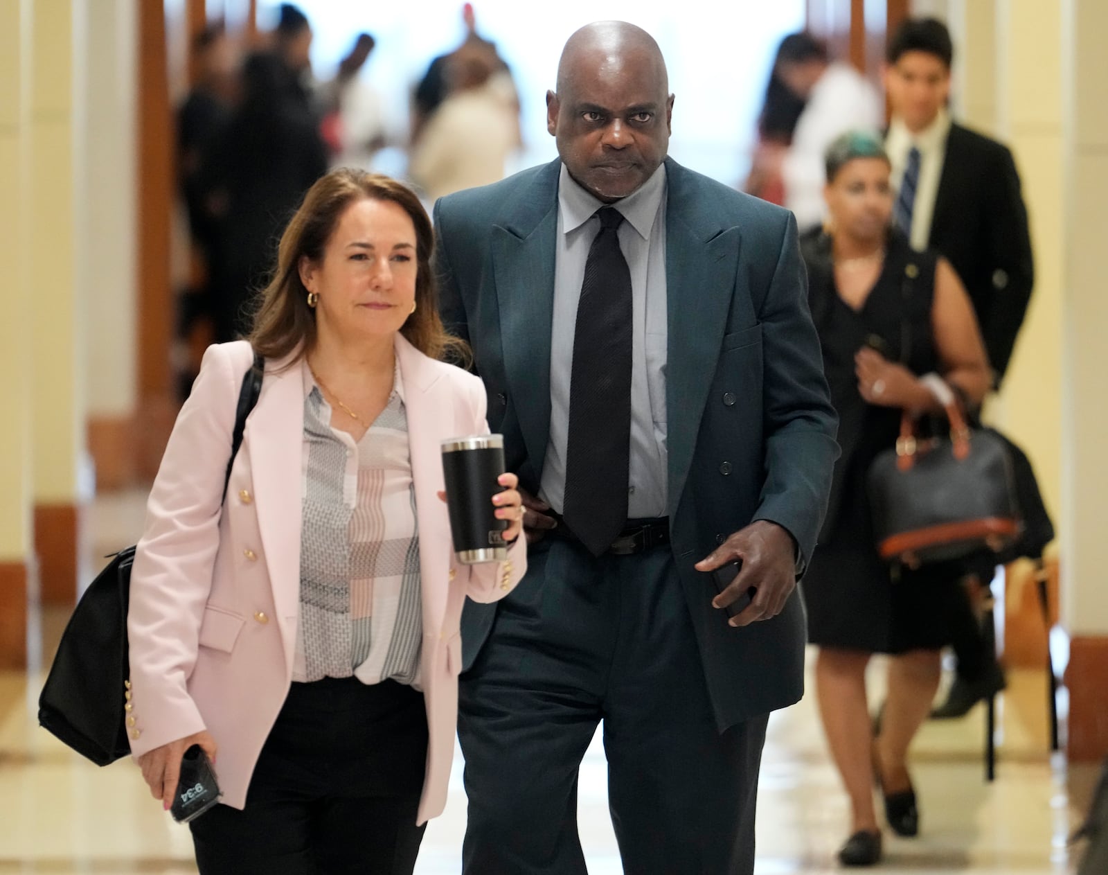 Defense attorney Nicole DeBorde Hochglaube, left, and her client, former Houston police officer Gerald Goines, arrive to the 482nd District Court to await a verdict in his murder trial at the Harris County Criminal courthouse Wednesday, Sept. 25, 2024, in Houston. Goines faces two felony murder charges in the January 2019 deaths of Dennis Tuttle and Rhogena Nicholas. (Melissa Phillip/Houston Chronicle via AP)