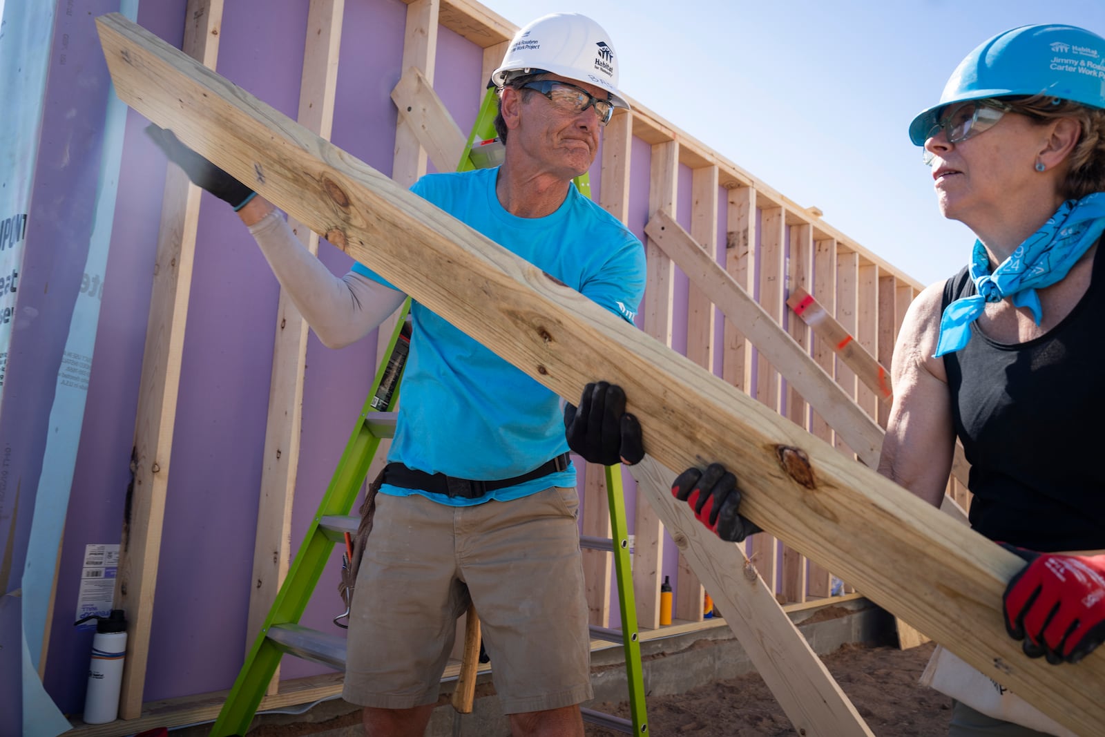 Volunteers Barry Mason, left, and Gwenn Branstad work to build a house during Twin Cities Habitat for Humanity's 2024 Jimmy & Rosalynn Carter Work Project at the site of the former Hillcrest Golf Course in St. Paul, Minn. on Monday, Sept. 30, 2024. (Leila Navidi /Star Tribune via AP)