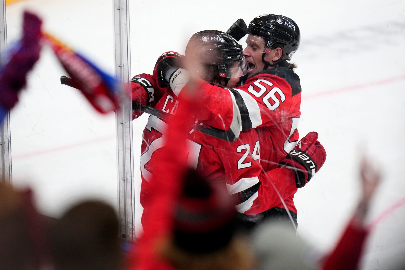 New Jersey Devils' Seamus Casey, left, celebrates with New Jersey Devils' Erik Haula after scoring his sides first goal during the NHL hockey game between Buffalo Sabres and New Jersey Devils, in Prague, Czech Republic, Saturday, Oct. 5, 2024. (AP Photo/Petr David Josek)