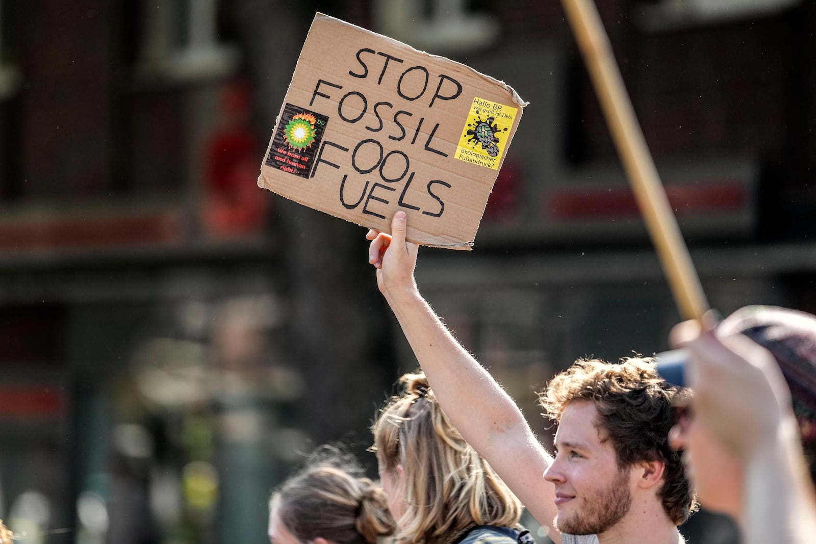 People demonstrate with a sign reading "stop fossil fuels" in the City of Bochum, western Germany, as they take part in a Global Climate Strike protest of the Fridays For Future movement on Friday, Sept. 20, 2024. (AP Photo/Martin Meissner)