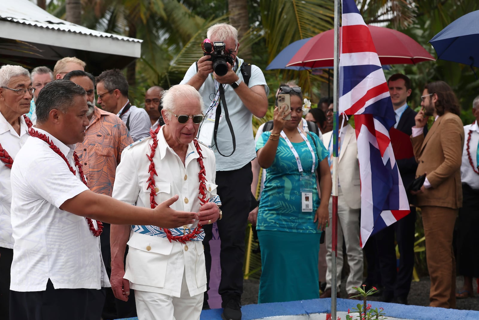 Britain's King Charles III, second left in front, visits the Mangrove Restoration Project at Moata'a Village in Apia, Samoa Thursday, Oct. 24, 2024. (Manaui Faulalo/Pool Photo via AP)