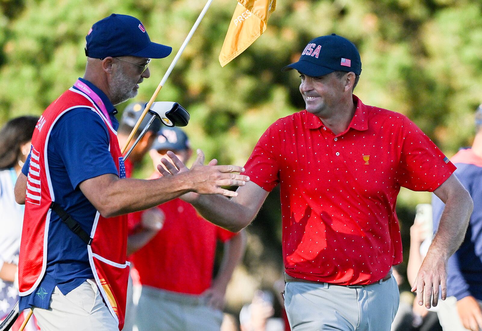 United States team member Keegan Bradley, right, celebrates with caddie Scott Vail, left, following his win over International team member Si Woo Kim, of South Korea, in their fifth-round singles match at the Presidents Cup at the Royal Montreal Golf Club in Montreal, Sunday, Sept. 29, 2024. (Graham Hughes/The Canadian Press via AP)