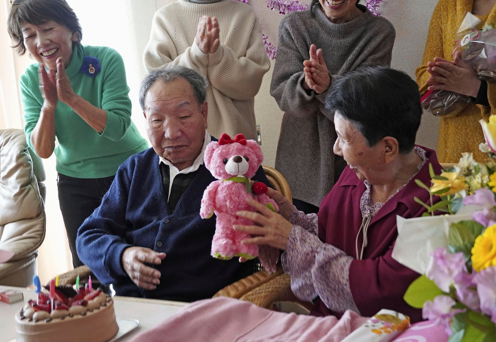 Iwao Hakamada, front left, who has been sentenced to death in a 1966 quadruple murder case, presents a stuffed toy bear to his sister Hideko Hakamada, right, on her 91st birthday in Hamamatsu, Shizuoka prefecture, central Japan, on Feb. 8, 2024. Japanese prosecutors said on Oct. 8, 2024 they will not appeal the Sept. 26 ruling of the Shizuoka District Court that acquitted the world’s longest-serving death-row inmate in a retrial. (Kyodo News via AP)