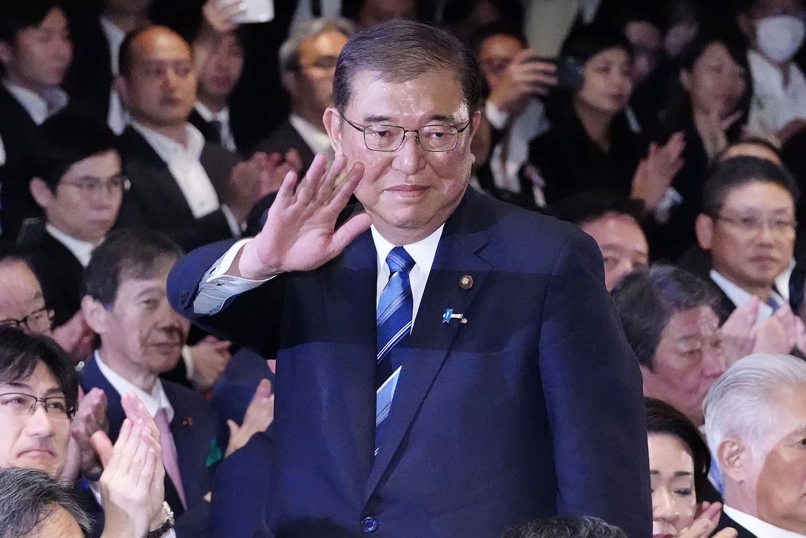 Shigeru Ishiba, center, waves as he is elected as leader of the ruling Liberal Democratic Party after the party's leadership election, in Tokyo Friday, Sept. 27, 2024. (Kyodo News via AP)