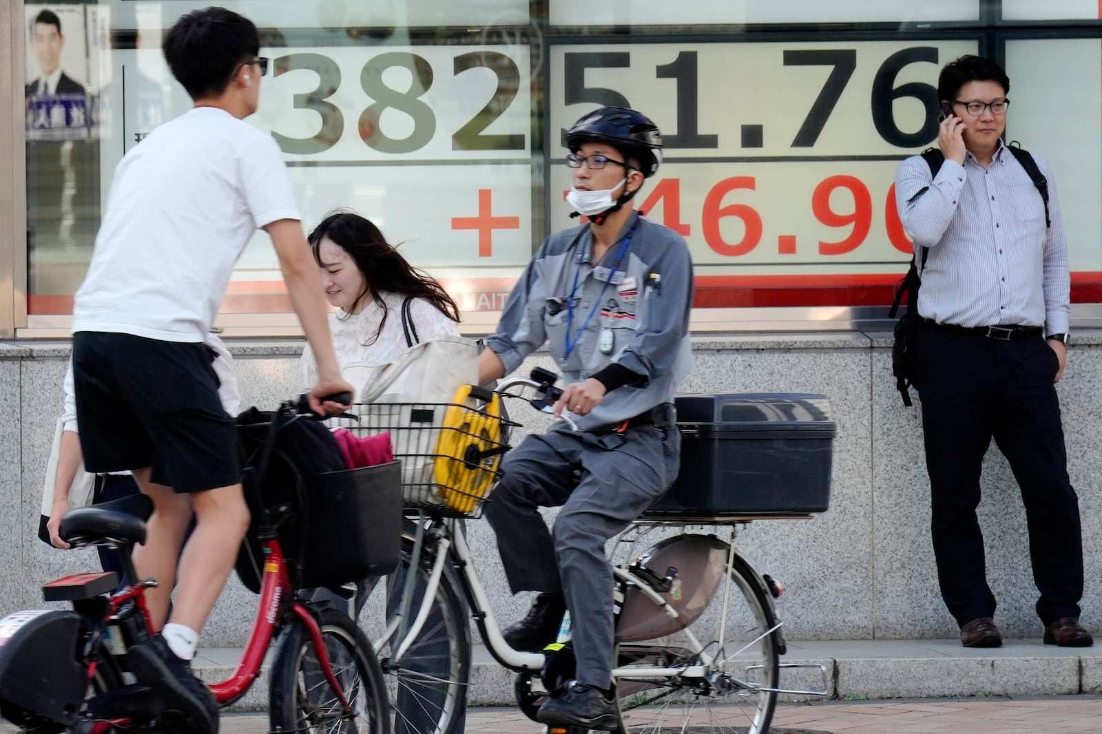 An electronic stock board showing Japan's Nikkei index at a securities firm is seen near a pedestrian crossing Thursday, Oct. 24, 2024, in Tokyo. (AP Photo/Eugene Hoshiko)