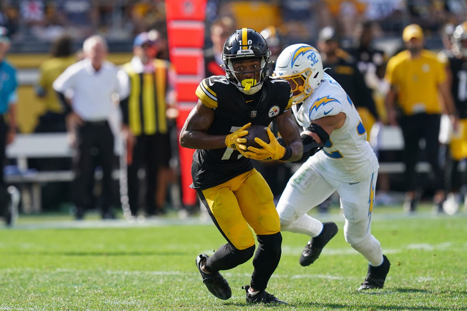 Pittsburgh Steelers wide receiver Calvin Austin III, left, runs with the ball on his way to a touchdown during the second half of an NFL football game against the Los Angeles Chargers, Sunday, Sept. 22, 2024, in Pittsburgh. (AP Photo/Matt Freed)