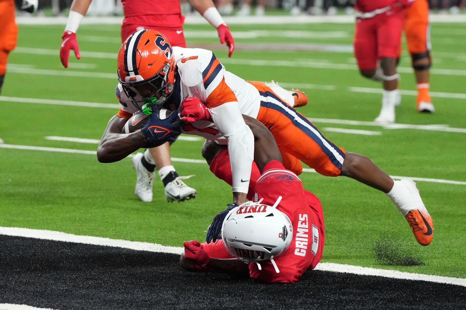 Syracuse running back LeQuint Allen (1) scores a touchdown over UNLV defensive back Tony Grimes, bottom, in the first half during an NCAA college football game, Friday, Oct. 4, 2024, in Las Vegas. (AP Photo/Rick Scuteri)