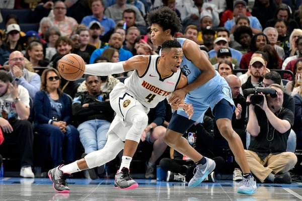 Denver Nuggets guard Russell Westbrook (4) drives against Memphis Grizzlies forward Jaylen Wells in the first half of an Emirates NBA Cup basketball game Tuesday, Nov. 19, 2024, in Memphis, Tenn. (AP Photo/Brandon Dill)