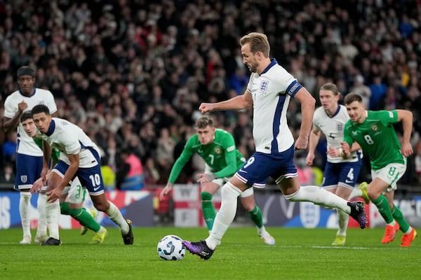 England's Harry Kane scores the opening goal from the penalty spot during the UEFA Nations League soccer match between England and the Republic of Ireland at Wembley stadium in London, Sunday, Nov. 17, 2024. (AP Photo/Kin Cheung)