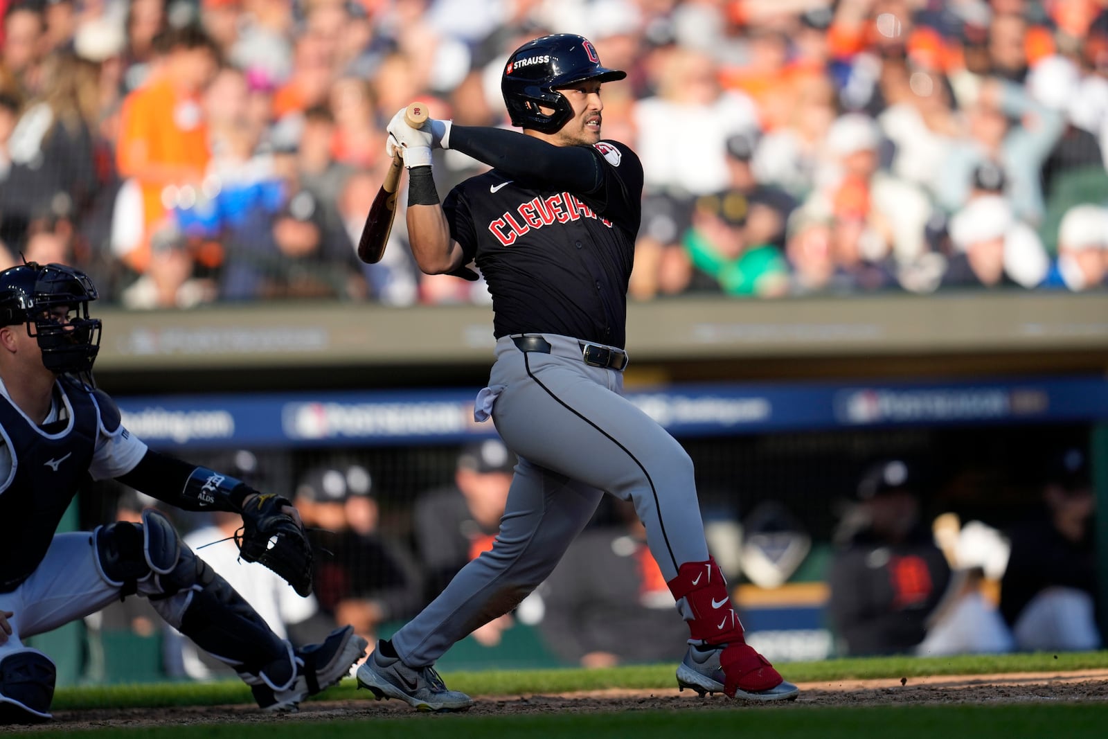 Cleveland Guardians' Steven Kwan hits a single in the seventh inning during Game 3 of a baseball American League Division Series against the Detroit Tigers, Wednesday, Oct. 9, 2024, in Detroit. (AP Photo/Paul Sancya)