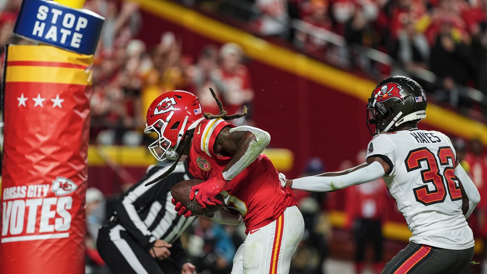 Kansas City Chiefs wide receiver DeAndre Hopkins (8) scores a touchdown against Tampa Bay Buccaneers safety Josh Hayes (32) during the first half of an NFL football game, Monday, Nov. 4, 2024, in Kansas City, Mo. (AP Photo/Charlie Riedel)