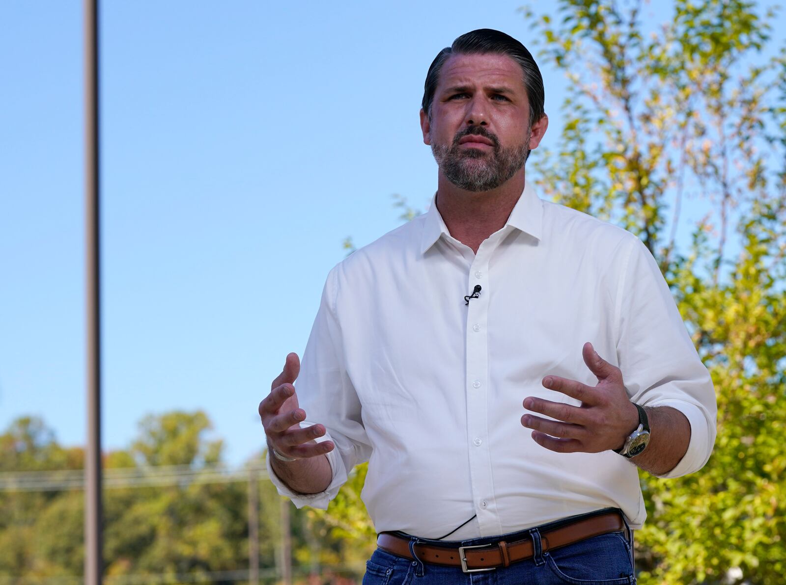 Republican congressional candidate Derrick Anderson gestures during an interview at an early voting station in Stafford, Va., Wednesday, Oct. 23, 2024. Anderson is running against Democrat Eugene Vindman in the 7th Congressional race. (AP Photo/Steve Helber)