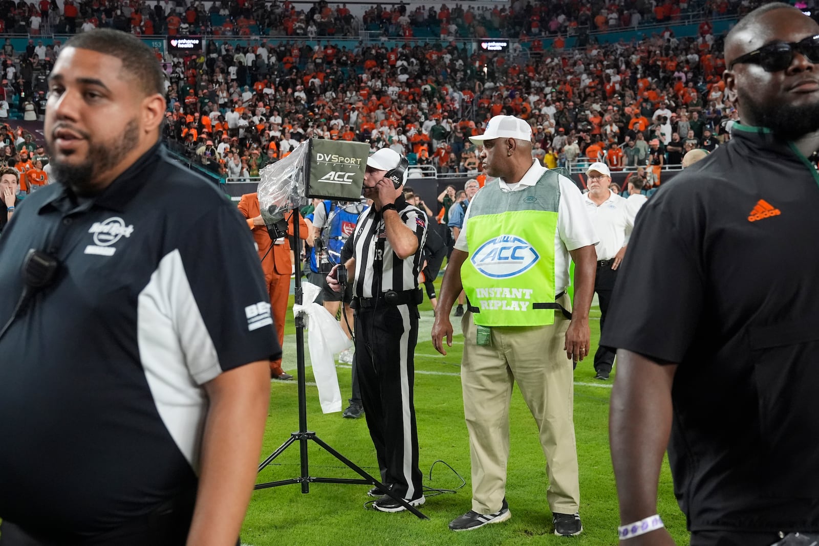 An NCAA official reviews a play at the end of the last second of an NCAA college football game, Friday, Sept. 27, 2024, in Miami Gardens, Fla. The play was first ruled a touchdown and then after a lengthy review it was reversed to an incomplete pass. (AP Photo/Marta Lavandier)