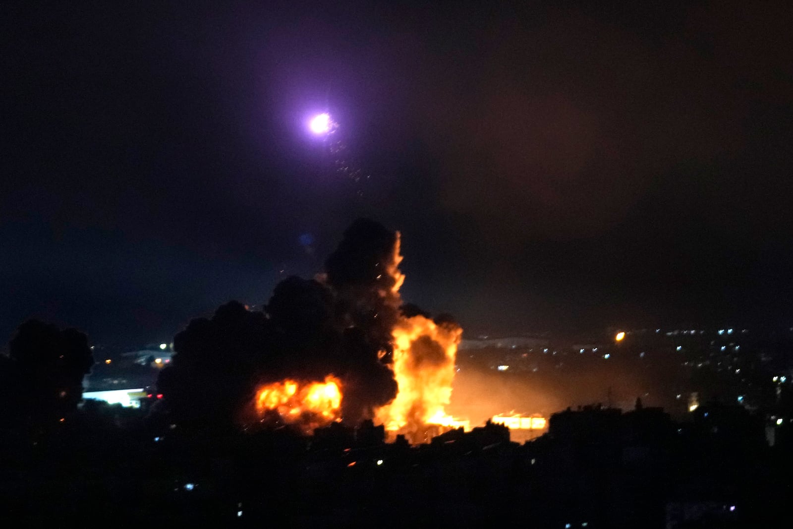 Flames rise from Israeli airstrikes in Dahiyeh, Beirut, Lebanon, Friday, Oct. 4, 2024. (AP Photo/Hussein Malla)