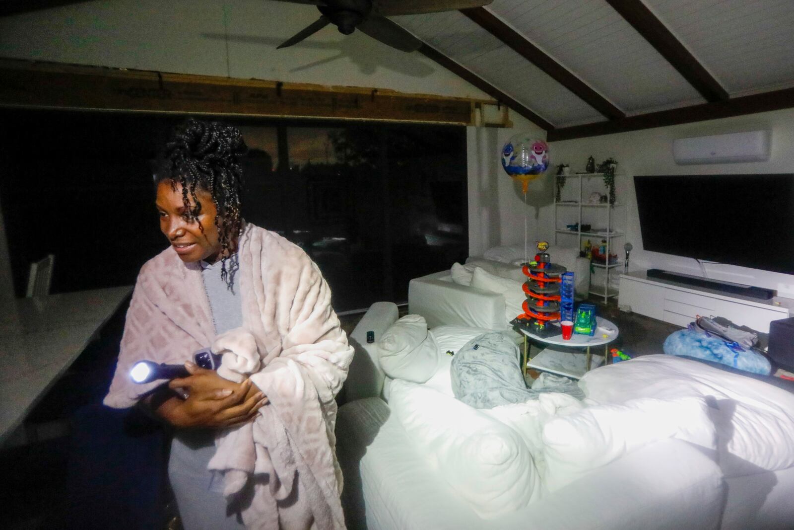 Clarissa Lucky gives a tour of her home that flooded from Hurricane Helene near DeSoto Park, Fla., on Friday, Sept. 27, 2024, in Tampa. (Jefferee Woo/Tampa Bay Times via AP)