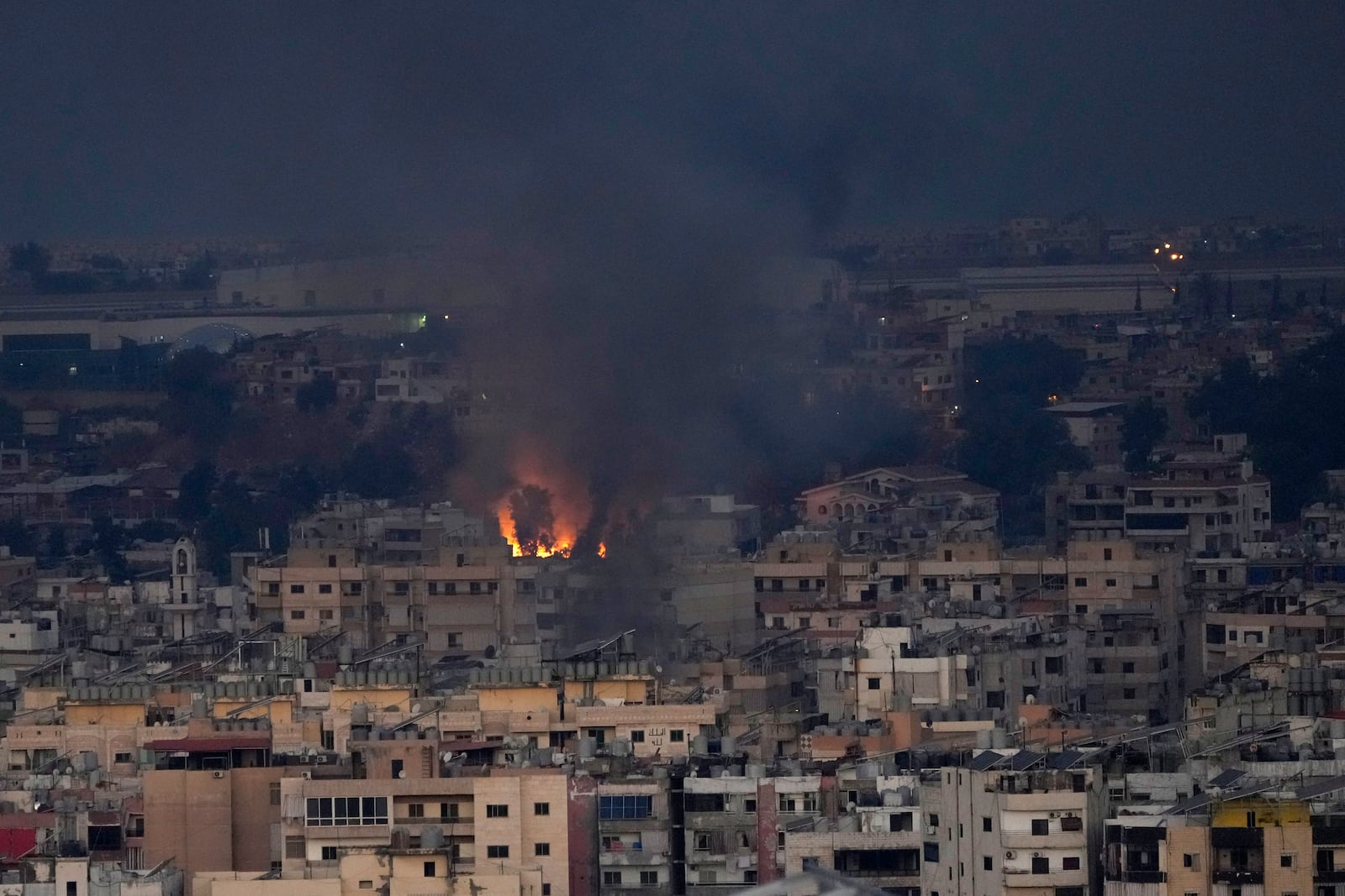 Flame and smoke rise from Israeli airstrikes hit a residential area that is a Hezbollah stronghold, in the southern suburbs of Beirut, Lebanon, Saturday, Sept. 28, 2024. (AP Photo/Hussein Malla)