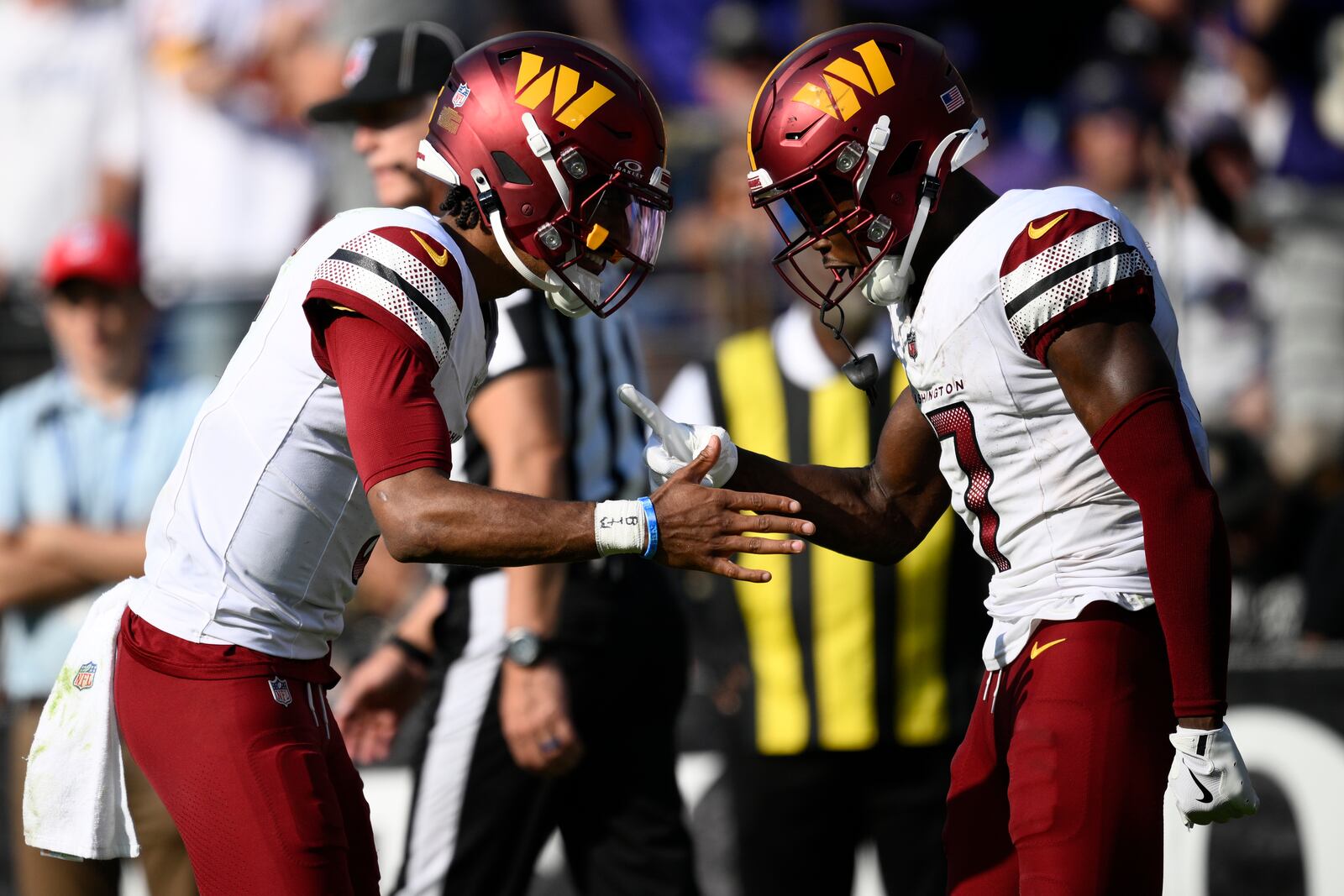 Washington Commanders wide receiver Terry McLaurin, right, is congratulated by quarterback Jayden Daniels after catching a 6-yard touchdown pass during the second half of an NFL football game against the Baltimore Ravens Sunday, Oct. 13, 2024, in Baltimore. (AP Photo/Nick Wass)