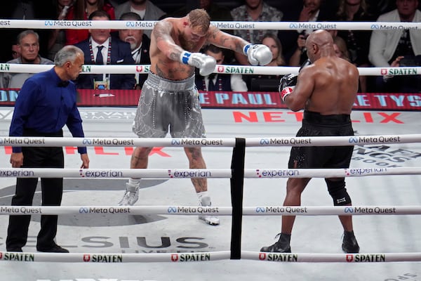 Jake Paul motions towards Mike Tyson during their heavyweight boxing match, Friday, Nov. 15, 2024, in Arlington, Texas. (AP Photo/Julio Cortez)