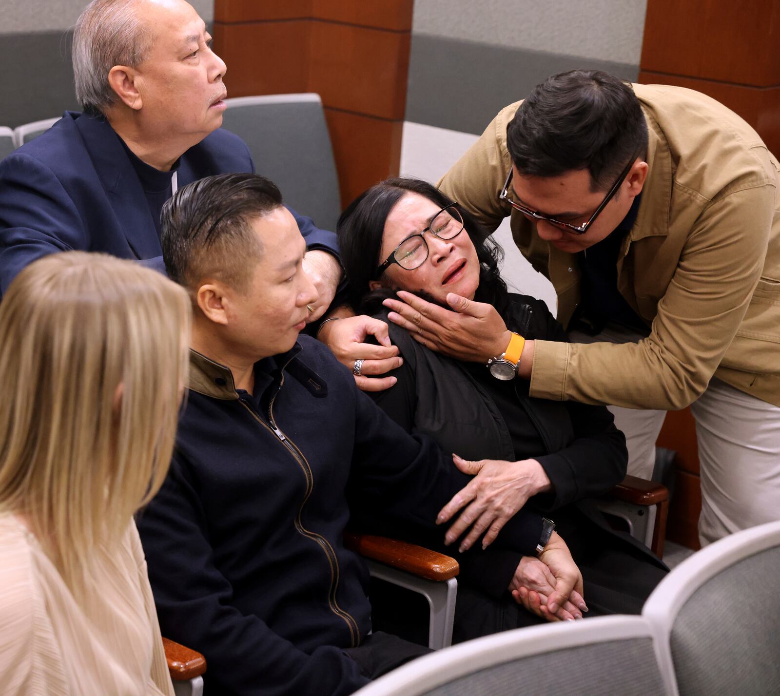 Bong Le, mother of a stabbing victim Khuong Nguyen, reacts to the guilty verdict in defendant Julius Trotter's murder trial, Tuesday, Oct. 29, 2024, at the Regional Justice Center in Las Vegas. Comforting Le is Hung Quang Nguyen, husband of a stabbing victim Sang Nghia, second left, and Tuan Trinh. At rear is interpreter Jimmy Tong Nguyen. ( (K.M. Cannon/Las Vegas Review-Journal via AP)