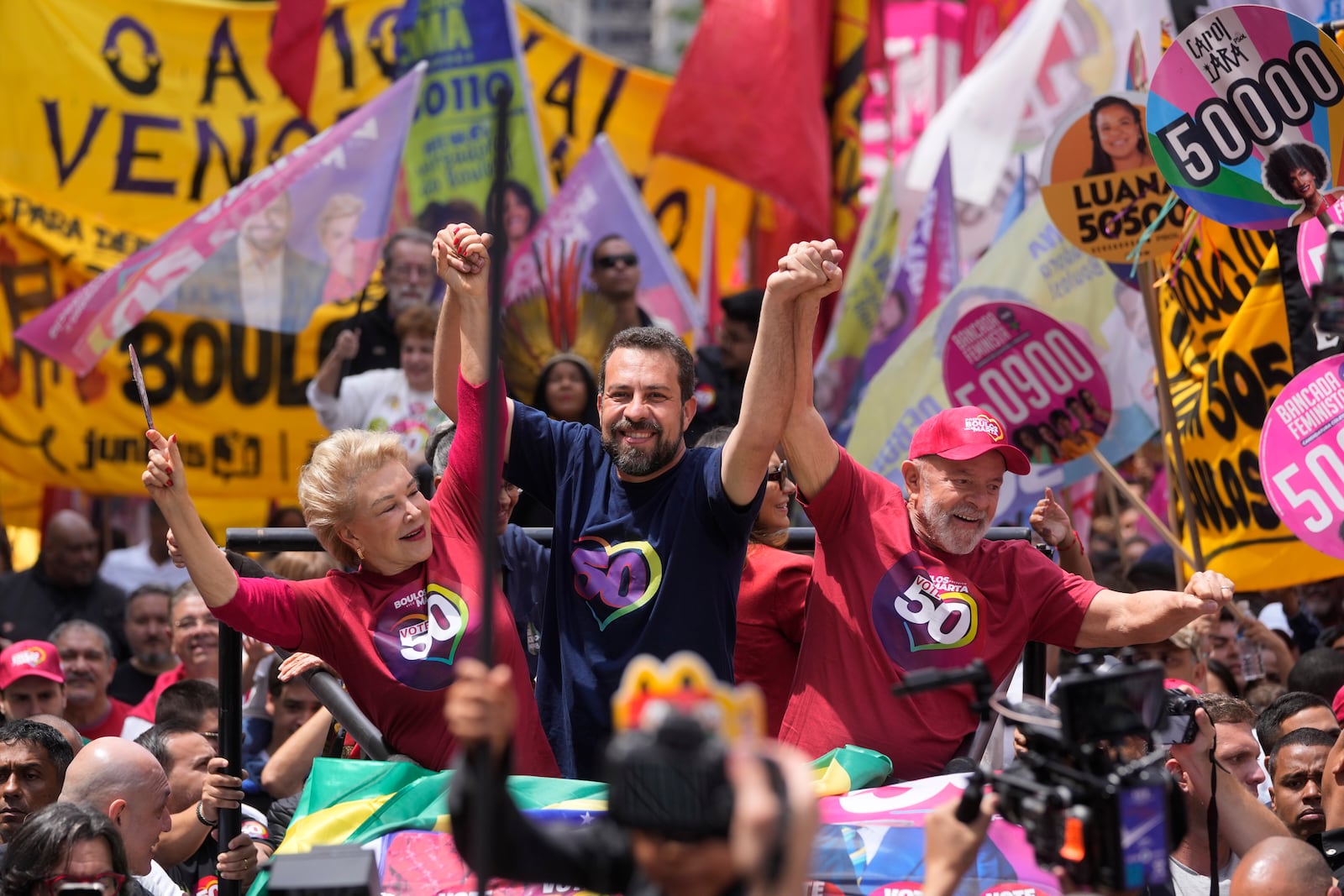 Mayoral candidate Guilherme Boulos of the Socialism and Liberty Party, center, campaigns with Brazilian President Luiz Inacio Lula da Silva, right, and his running mate Marta Suplicy, left, the day before elections in Sao Paulo, Saturday, Oct. 5, 2024. (AP Photo/Andre Penner)