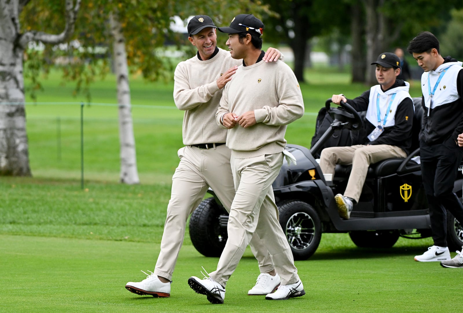 International team members Adam Scott, of Australia, left, and Hideki Matsuyama, of Japan, chat during a practice round at the Presidents Cup golf tournament at Royal Montreal Golf Club in Montreal, Tuesday, Sept. 24, 2024. (Graham Hughes/The Canadian Press via AP)