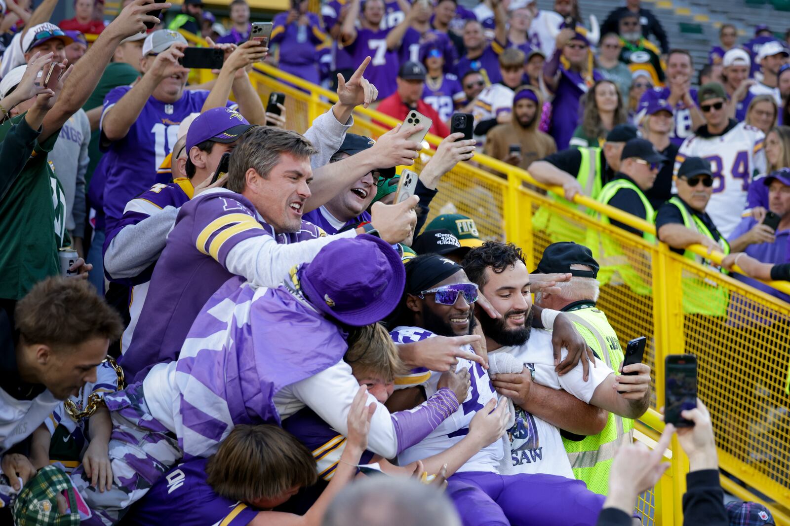 Minnesota Vikings running back Aaron Jones (33) celebrates with fans after the team's win against the Green Bay Packers in an NFL football game Sunday, Sept. 29, 2024, in Green Bay, Wis. (AP Photo/Matt Ludtke)