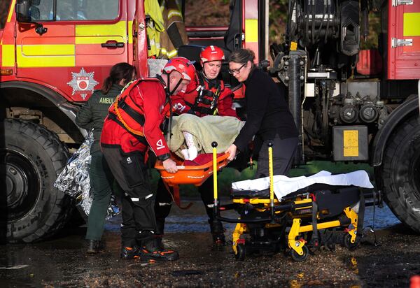 A local resident, wrapped in blankets, is attended to as she is lifted into an emergency vehicle at the Billing Aquadrome in Northamptonshire, England, Monday Nov. 25, 2024, after Storm Bert caused "devastating" flooding over the weekend. (Jordan Pettitt/PA via AP)