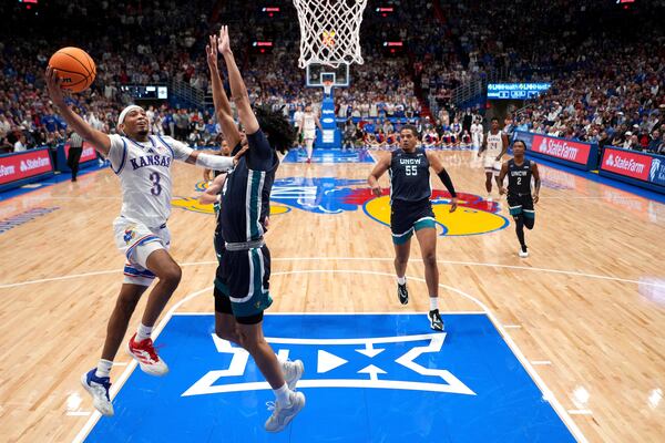 Kansas guard Dajuan Harris Jr. (3) puts up a shot during the first half of an NCAA college basketball game against UNC Wilmington Tuesday, Nov. 19, 2024, in Lawrence, Kan. (AP Photo/Charlie Riedel)