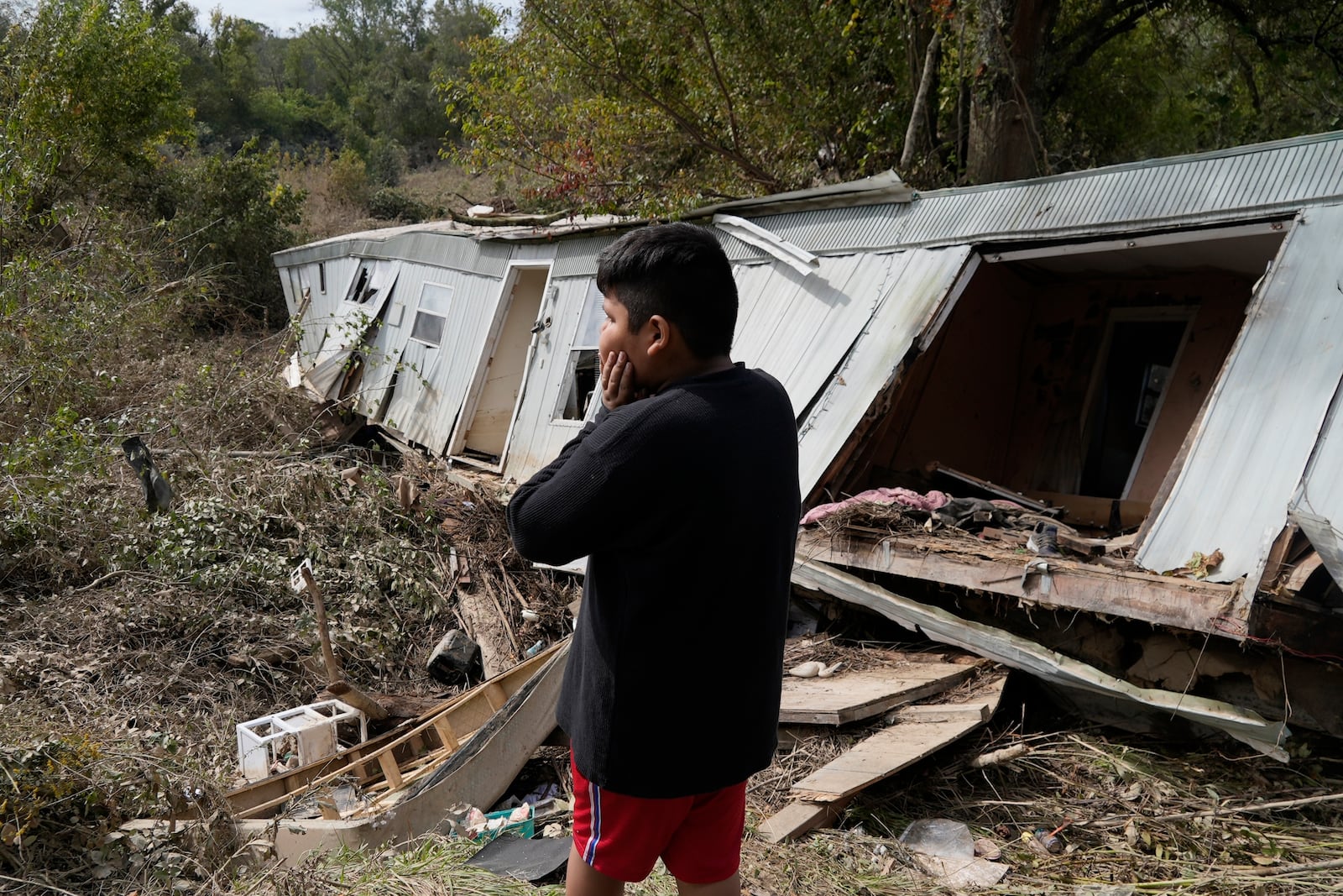 FILE - Gerardo Hernandez Juarez stares at what is left of his family's destroyed home, Oct. 1, 2024, in Hendersonville, N.C., in the aftermath of Hurricane Helene. (AP Photo/Brittany Peterson, File)