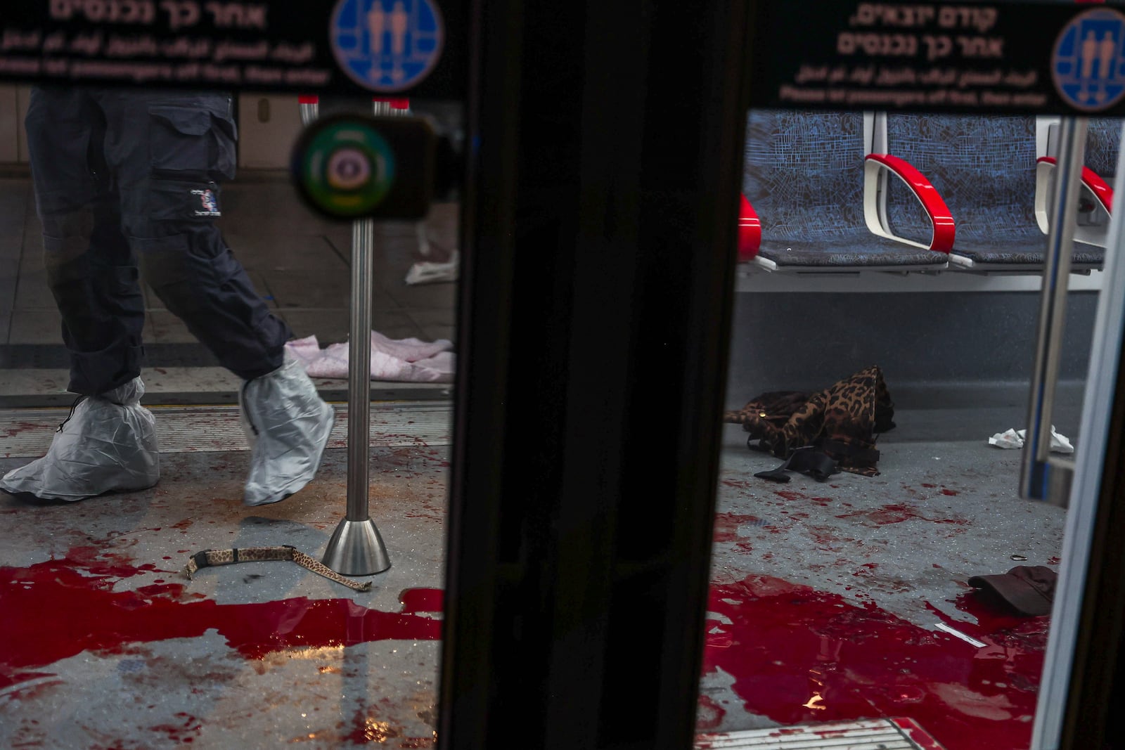 EDS NOTE: GRAPHIC CONTENT - Israeli forensic technicians work in a light rail car following a shooting attack in Jaffa, a mixed Arab-Jewish area of Tel Aviv, Israel, Tuesday, Oct. 1, 2024. (AP Photo/Itai Ron)