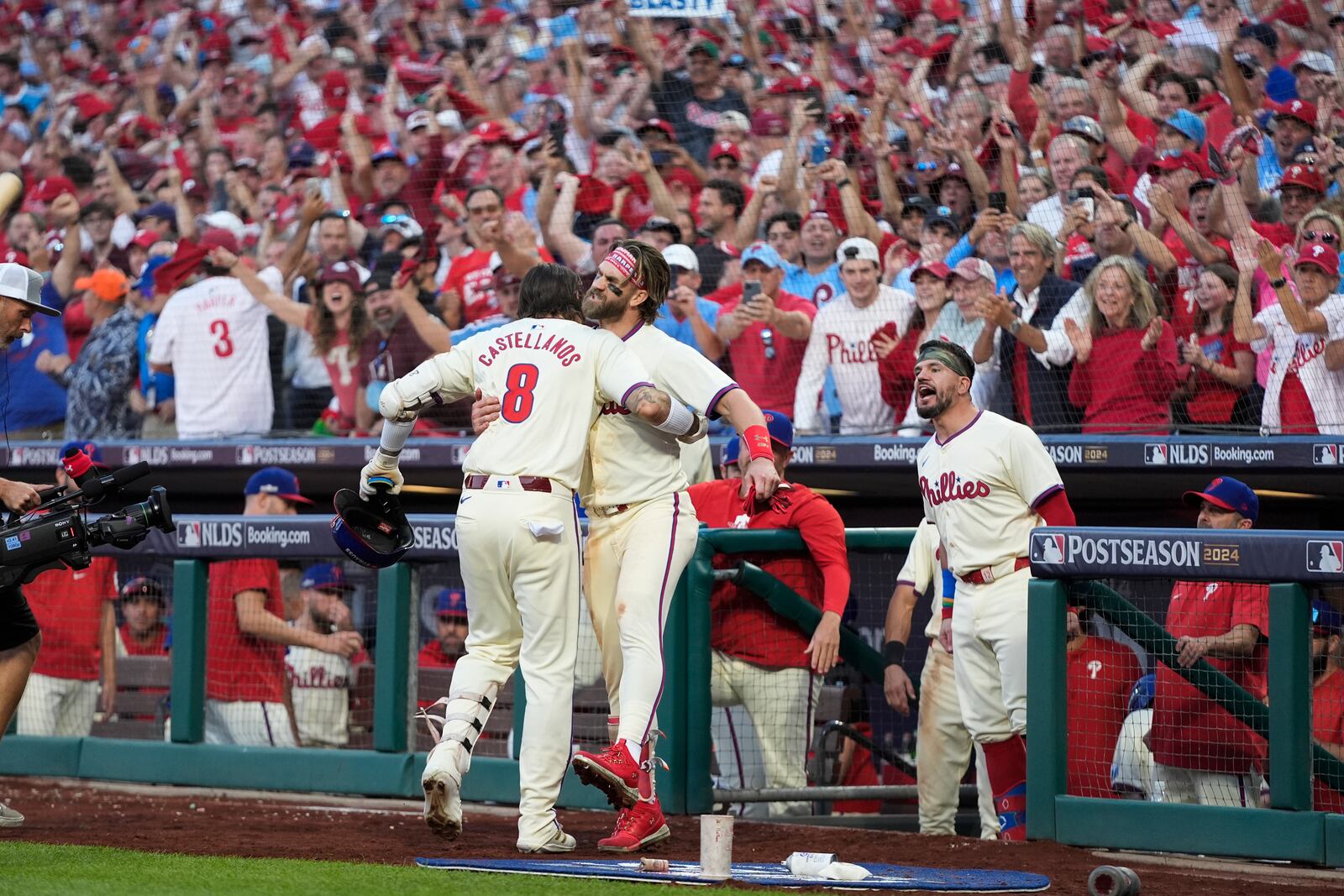 Philadelphia Phillies' Nick Castellanos (8) celebrates with Bryce Harper after hitting a home run against New York Mets pitcher Luis Severino during the sixth inning of Game 2 of a baseball NL Division Series, Sunday, Oct. 6, 2024, in Philadelphia. (AP Photo/Chris Szagola)