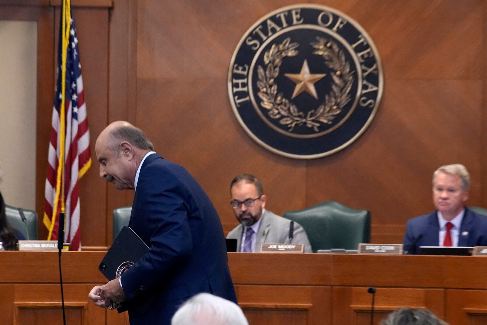 Dr. Phil McGraw, in blue suit, leaves the room after giving testimony to a committee discussing the case of death row inmate Robert Roberson, Monday, Oct. 21, 2024, in Austin, Texas. (AP Photo/Tony Gutierrez)