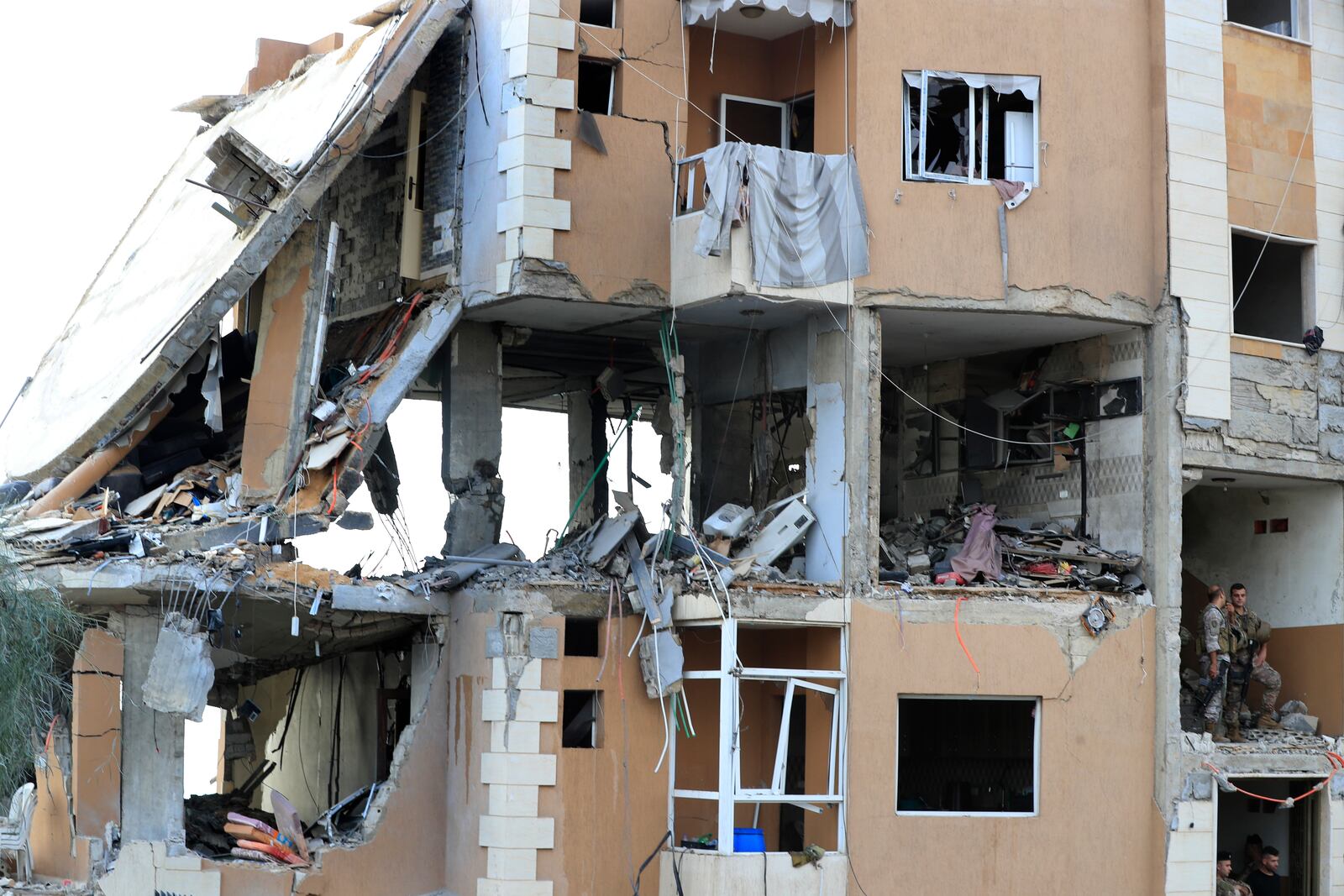 Lebanese army soldiers stand guard on a destroyed building hit by an Israeli airstrike, in Barja village, south of Beirut, Lebanon, Saturday, Oct. 12, 2024. (AP Photo/Mohammed Zaatari)