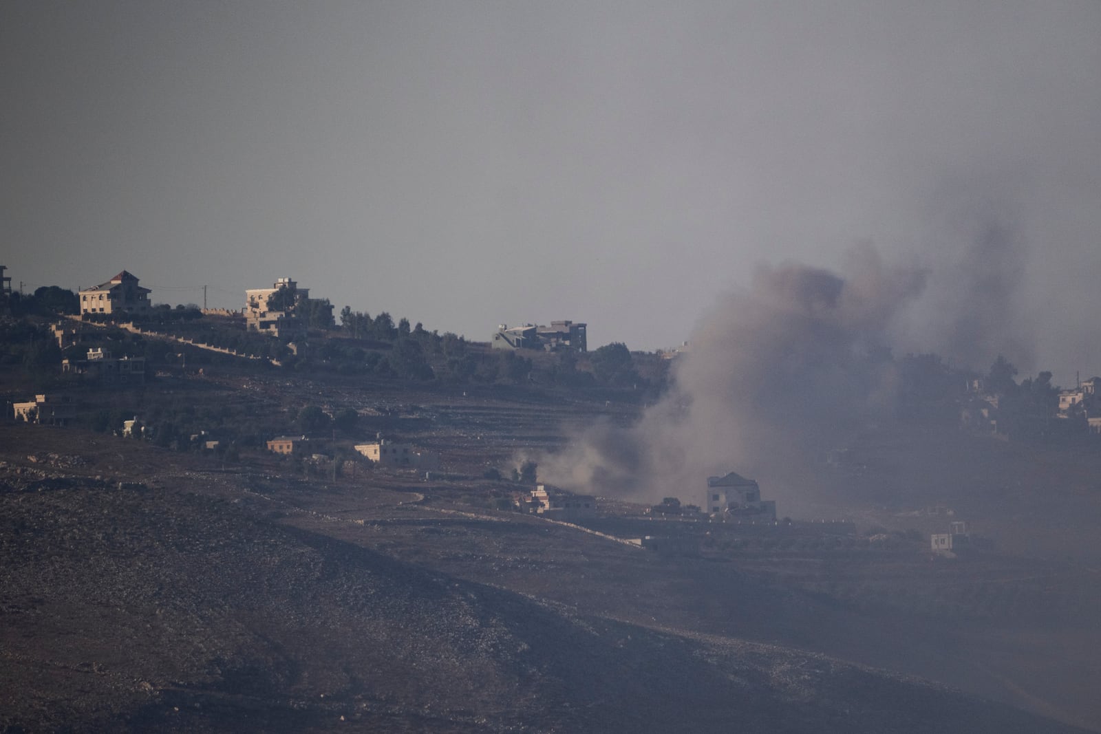 Smoke rises following an Israeli shelling in southern Lebanon as seen from northern Israel, Friday, Oct. 4, 2024. (AP Photo/Leo Correa)