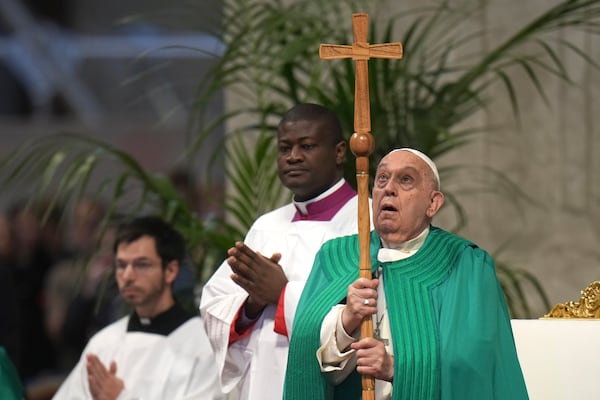 Pope Francis looks at the cross as he presides over a mass on the occasion of the World Day of the Poor in St. Peter's Basilica, at the Vatican, Sunday, Nov. 17, 2024. (AP Photo/Alessandra Tarantino)