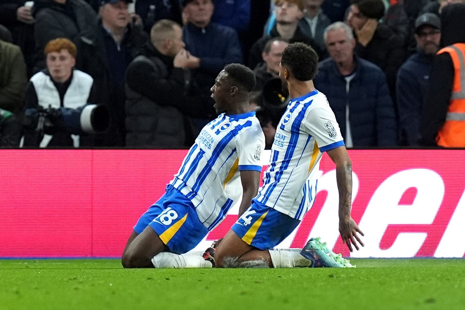 Brighton and Hove Albion's Danny Welbeck, left, celebrates scoring their side's third goal of the game with team-mate Georginio Rutter during the Premier League match at the American Express Stadium, Brighton, England, Sunday Oct. 6, 2024. (Gareth Fuller/PA via AP)