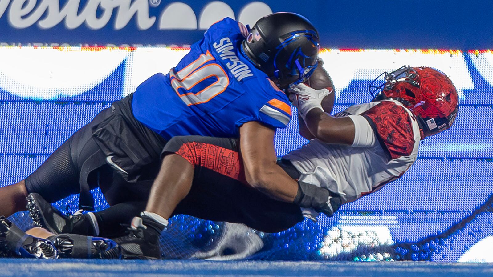 San Diego State running back Marquez Cooper scores a touchdown as Boise State linebacker Andrew Simpson makes the tackle in the end zone during the first half of an NCAA college football game, Friday, Nov. 1, 2024 in Boise, Idaho. (Darin Oswald/Idaho Statesman via AP)