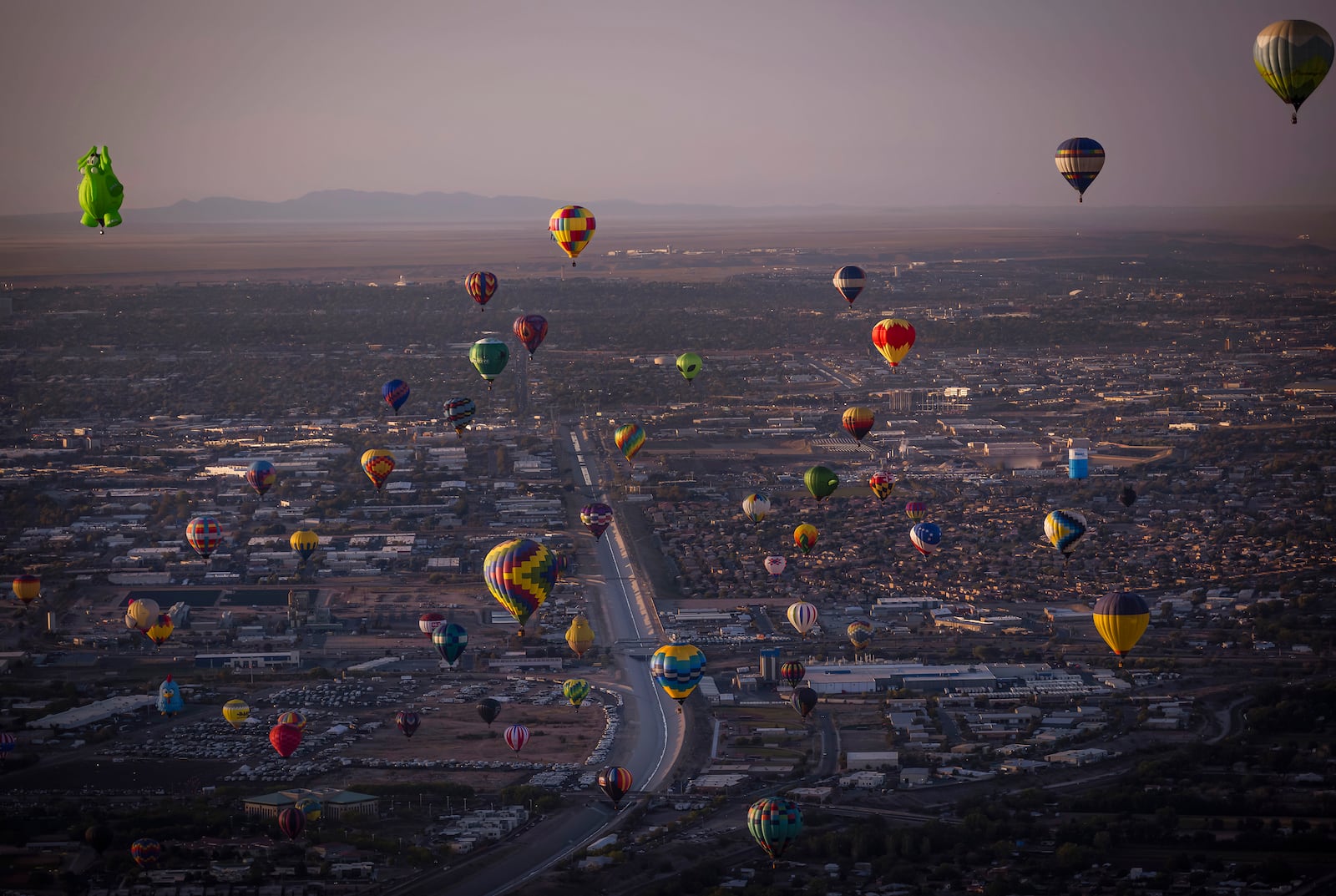 Balloons fly during the Albuquerque International Balloon Fiesta in Albuquerque, N.M., on Tuesday, Oct. 8, 2024.(Chancey Bush/The Albuquerque Journal via AP)