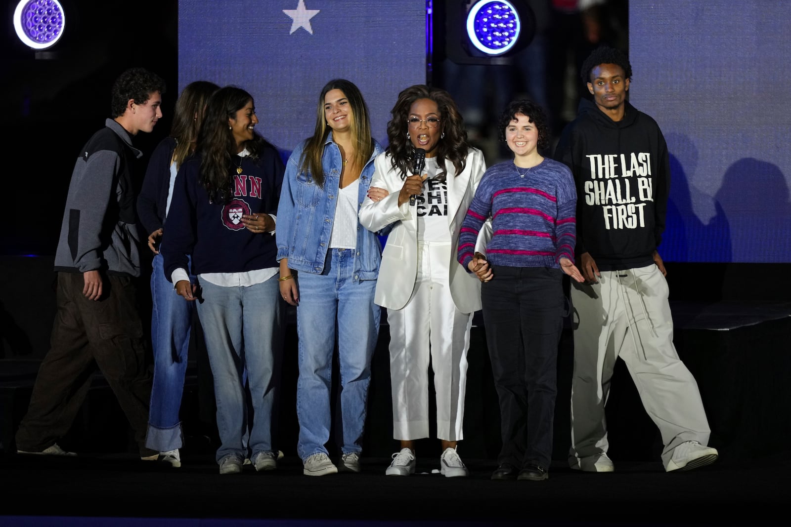 Oprah Winfrey, third from right, speaks as she stands on stage at a campaign rally supporting Democratic presidential nominee Vice President Kamala Harris outside the Philadelphia Museum of Art, Monday, Nov. 4, 2024, in Philadelphia. (AP Photo/Matt Slocum)