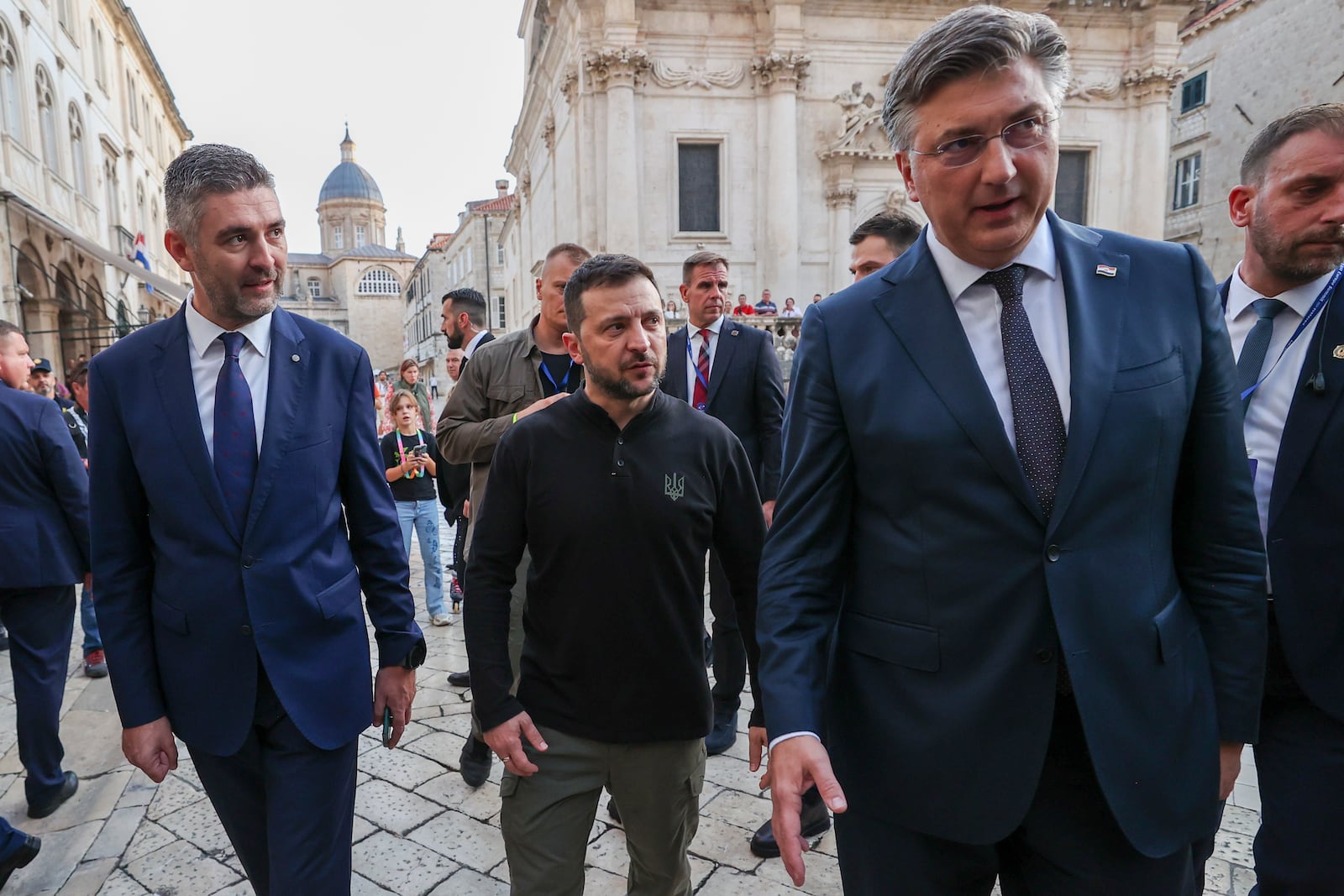 Ukrainian President Volodomyr Zelenskyy, center, walks through the old town with Dubrovnik mayor Mato Frankovic, left, and Croatian Prime Minister Andrej Plenkovic during a pause in the Southeast Europe Croatia Ukraine summit in Dubrovnik, Croatia, Wednesday, Oct. 9, 2024. (AP Photo)