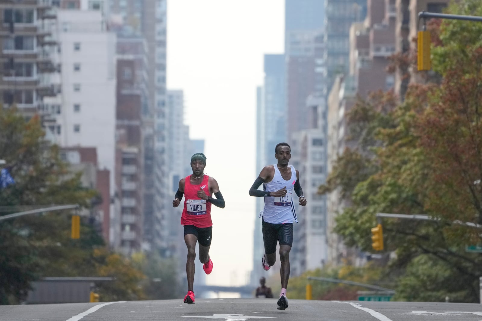 FILE - Tamirat Tola, of Ethiopia, right, and Jemal Yimer, of Ethiopia, left, lead the pack of elite men runners during the New York City Marathon in New York, Sunday, Nov. 5, 2023. (AP Photo/Seth Wenig, File)