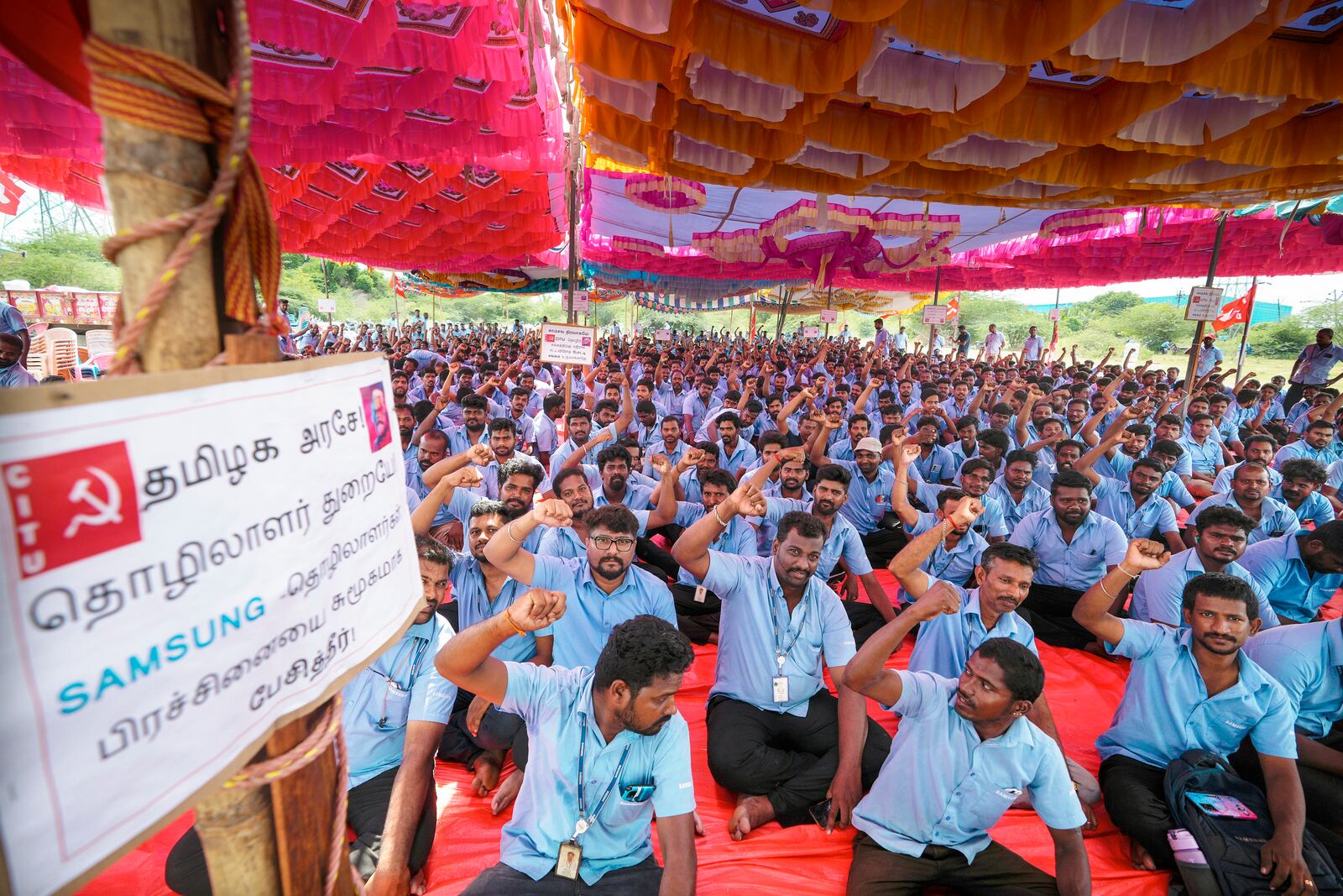 Samsung workers who are on strike shout slogans during a protest near their plant in Sriperumbudur, on the outskirts of Chennai, India, Tuesday, Sept. 24, 2024. (AP Photo/Mahesh Kumar A.)