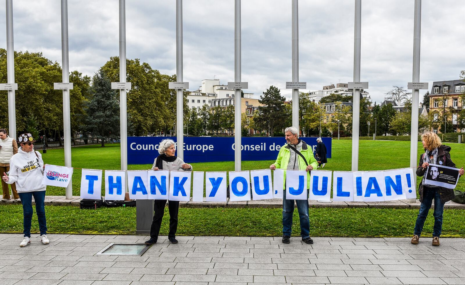 People hold a banner in support of Wikileaks founder Julian Assange outside at the Council of Europe in Strasbourg, eastern France, Tuesday, Oct. 1, 2024. (AP Photo/Pascal Bastien)