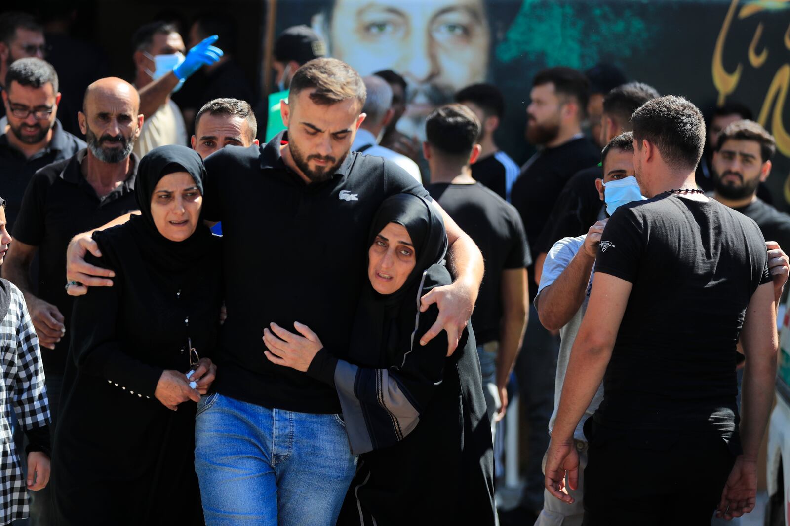 People react during the funeral procession of their relatives, who were killed in Monday's Israeli airstrikes, in the southern village of Saksakieh, Lebanon, Tuesday, Sept. 24, 2024. (AP Photo/Mohammed Zaatari)