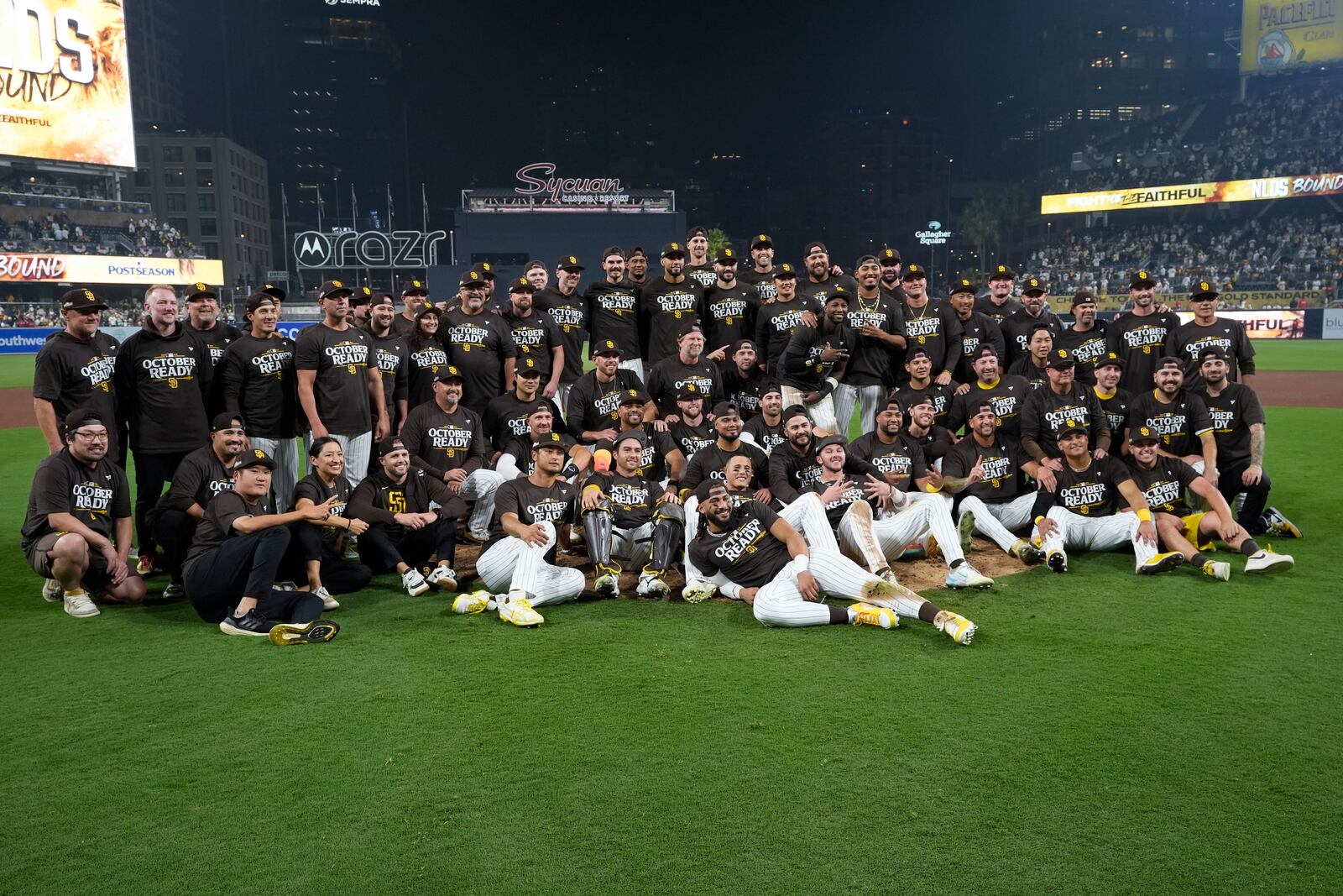 The San Diego Padres pose for a team photo after defeating the Atlanta Braves in Game 2 of an NL Wild Card Series baseball game Wednesday, Oct. 2, 2024, in San Diego. (AP Photo/Gregory Bull)