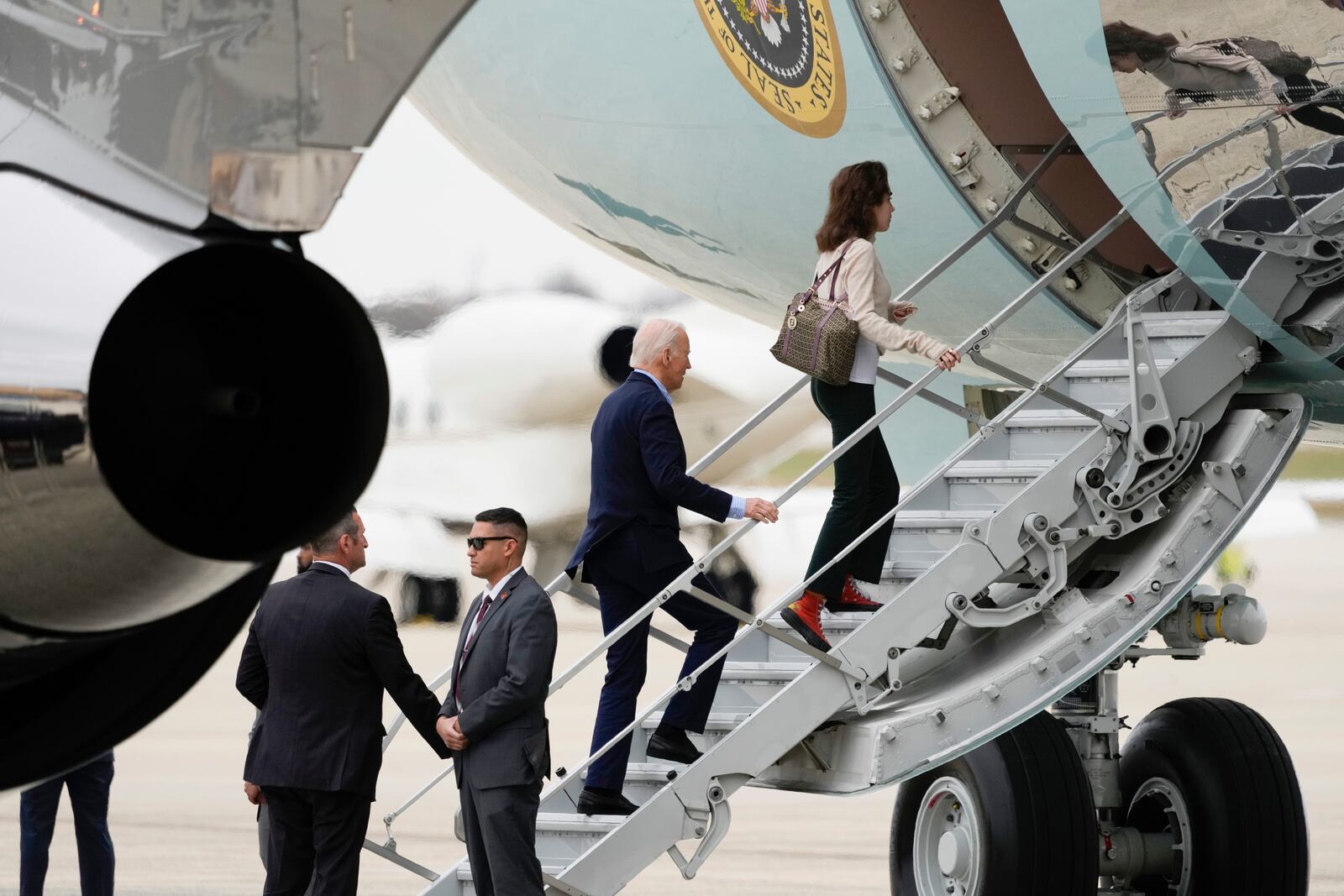 President Joe Biden boards Air Force One, with granddaughter Natalie Biden, to depart Joint Base Andrews, Md., Thursday, Nov. 14, 2024, en route to Lima, Peru to join other world leaders at the APEC Summit. (AP Photo/Ben Curtis)