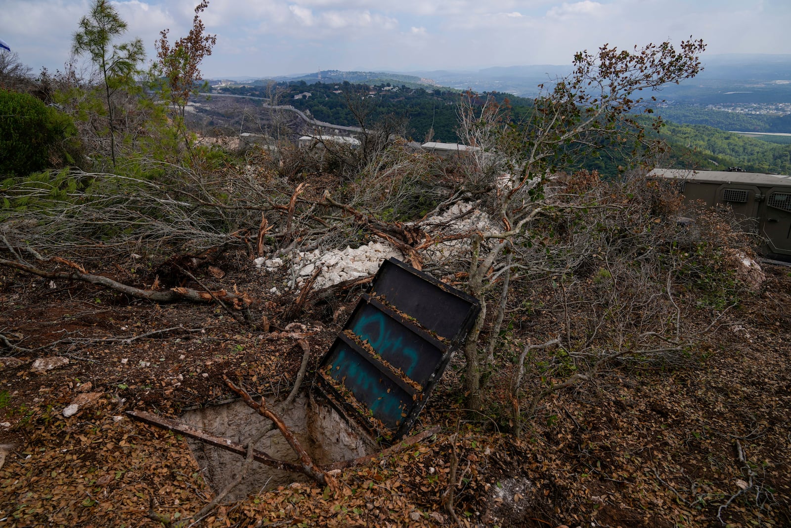 Israeli soldiers display what they say is an entrance to a Hezbollah tunnel found during their ground operation in southern Lebanon, near the border with Israel, Sunday, Oct. 13, 2024. (AP Photo/Sam McNeil)