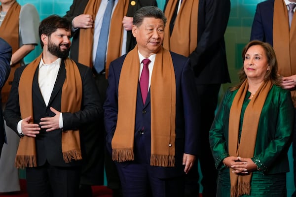 Chile's President Gabriel Boric, from left, China's President Xi Jinping and Peru's President Dina Boluarte gather for the leaders' group photo during the Asia-Pacific Economic Cooperation (APEC) summit, in Lima, Peru, Saturday, Nov. 16, 2024. (AP Photo/Fernando Vergara)